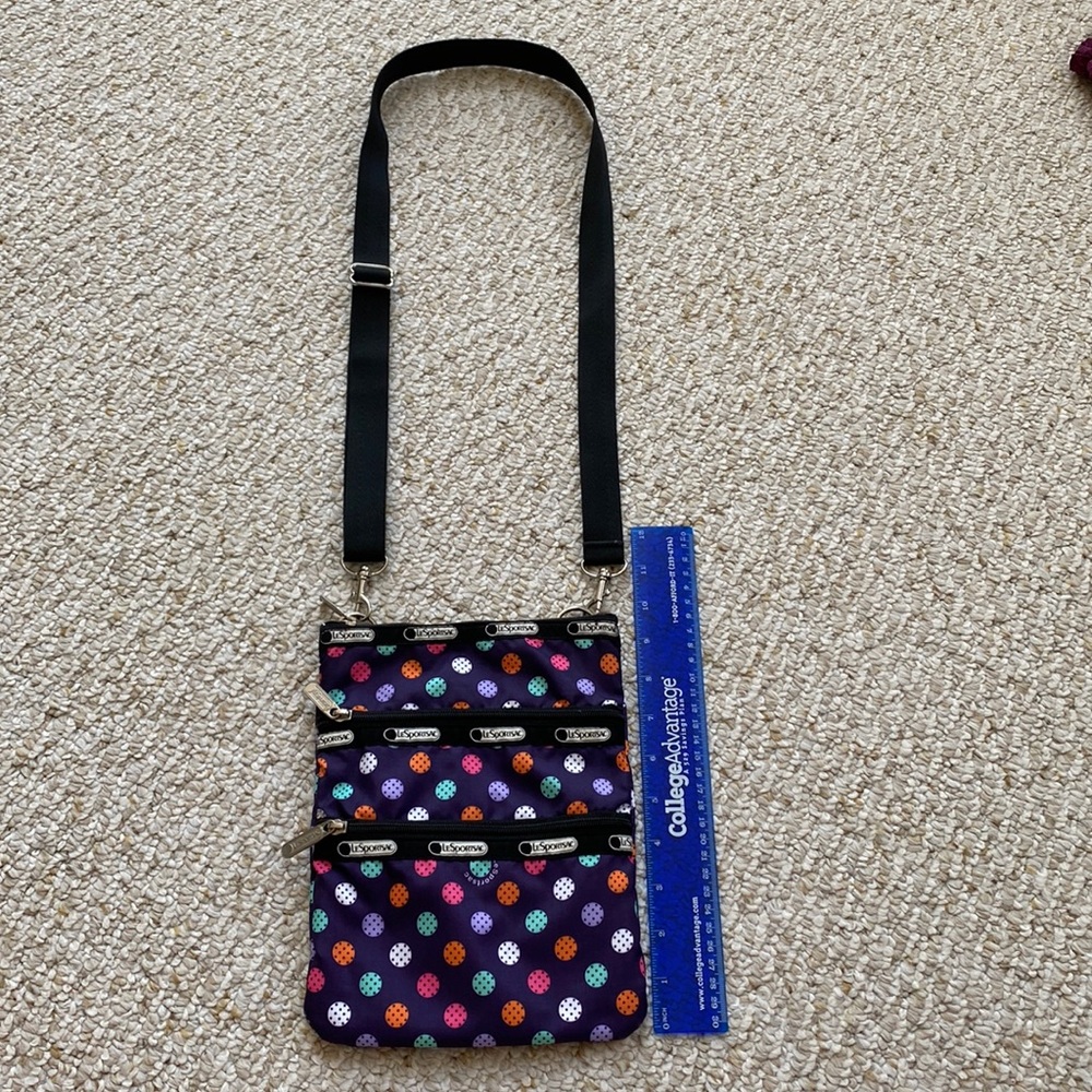 LeSportsac Purple polka dot crossbody with zippers and adjustable straps.